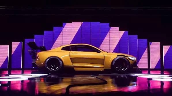 A still from a personalized launch trailer, featuring a custom yellow car on a lit stage